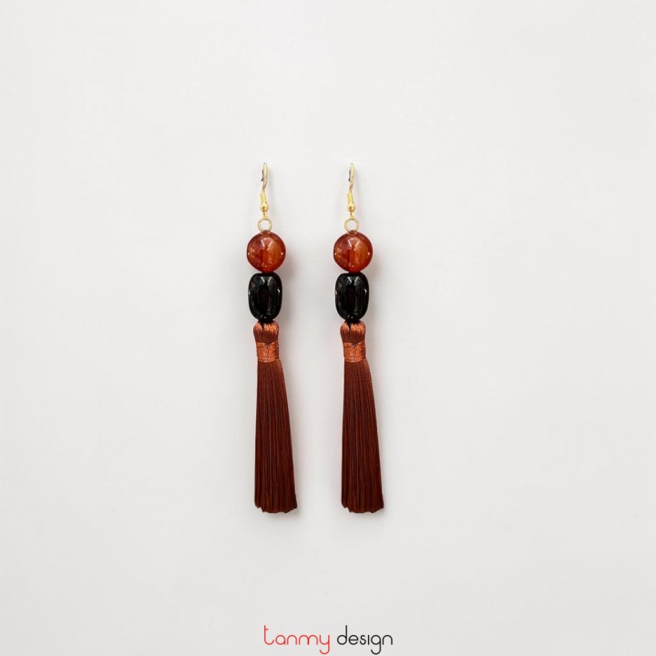 Earrings with orange agate beads, black agate, and brown tassels